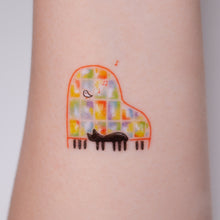Load image into Gallery viewer, Black Cat Napping on A Piano Safe, waterproof, and fashionable. Cute Matching Tattoo ideas, Black Cat Lucky Cat Body Art, Blessing Tattoo Ideas, Fun Animal Fashion Accessories, Pet Toy, Doodle Cat Tattoos, Piano Tattoos, Fairy Tale Accessories.
